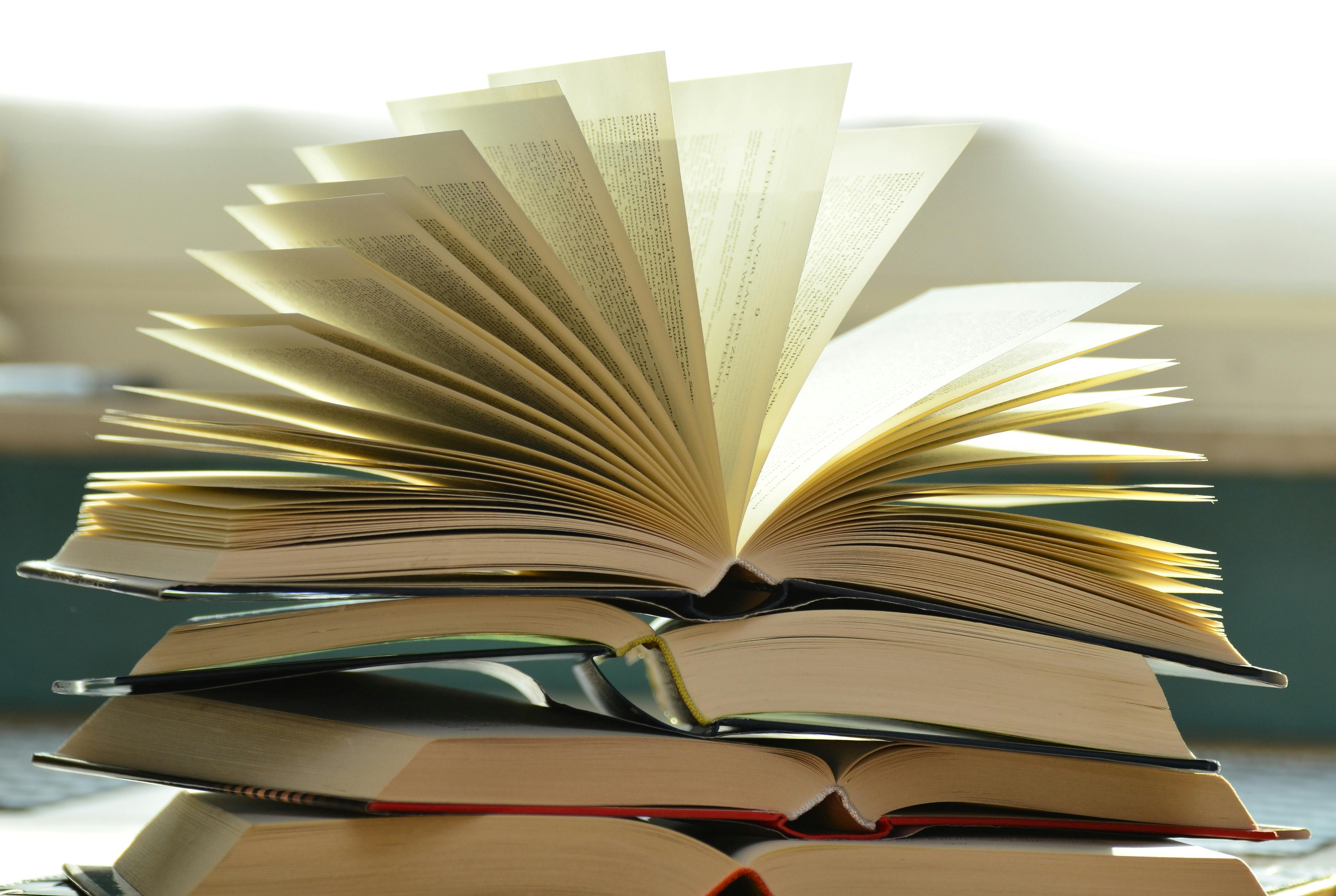 Stack of open books — understanding domestic violence